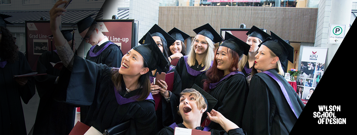 Graduates group together for an excited selfie.